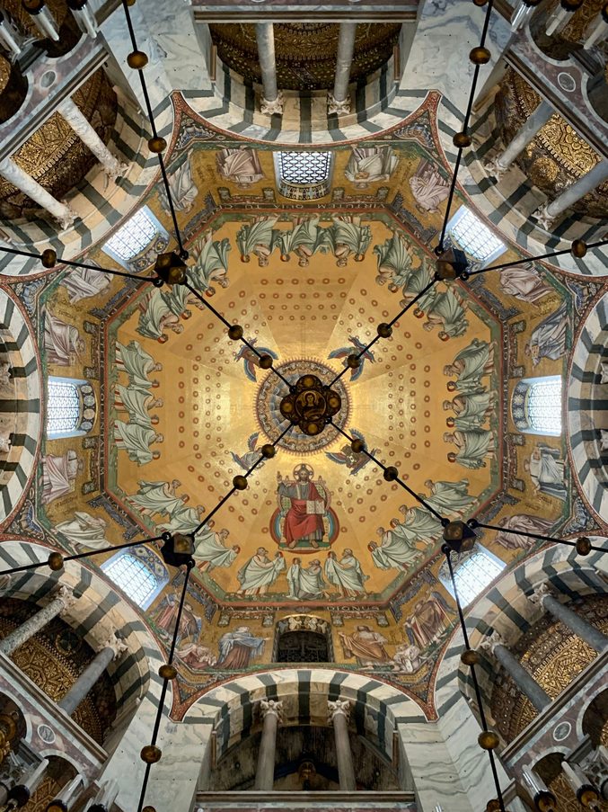 The gold mosaic of the dome of Aachen Cathedral, with the Barbarossa chandelier hanging below