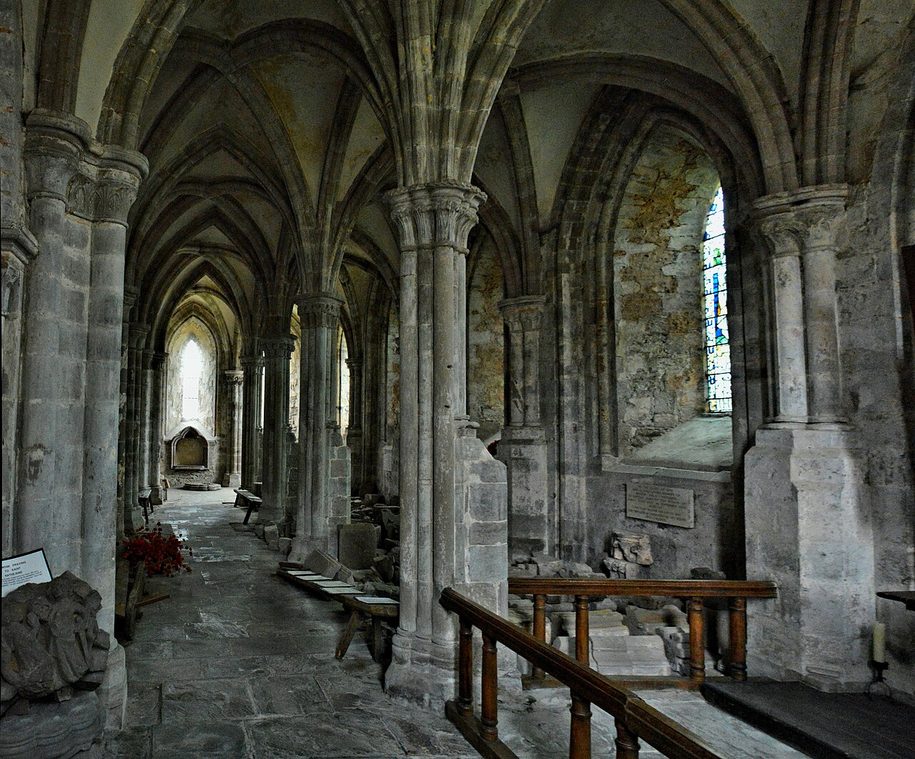 The vaulted ambulatory behind the high altar at Dore Abbey, a forest of slender stone columns and arches