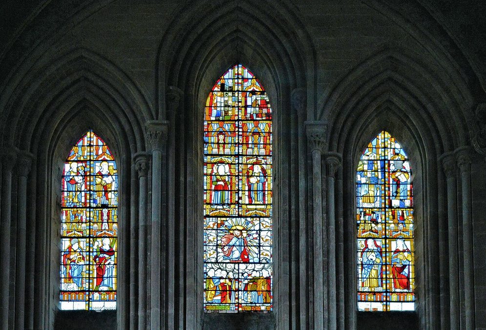 Three tall lancet windows of 1630s stained glass in the east wall of Dore Abbey