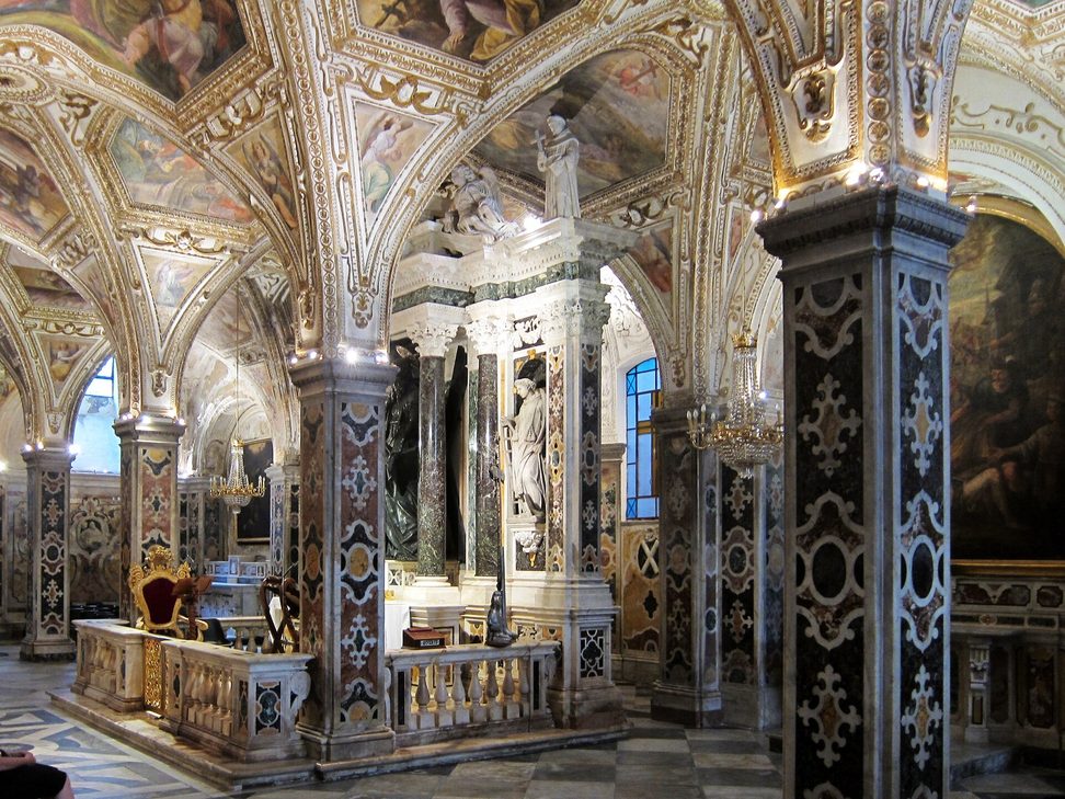The richly painted and marbled crypt of St Andrew under Amalfi Cathedral, with the bronze statue of the saint above the altar