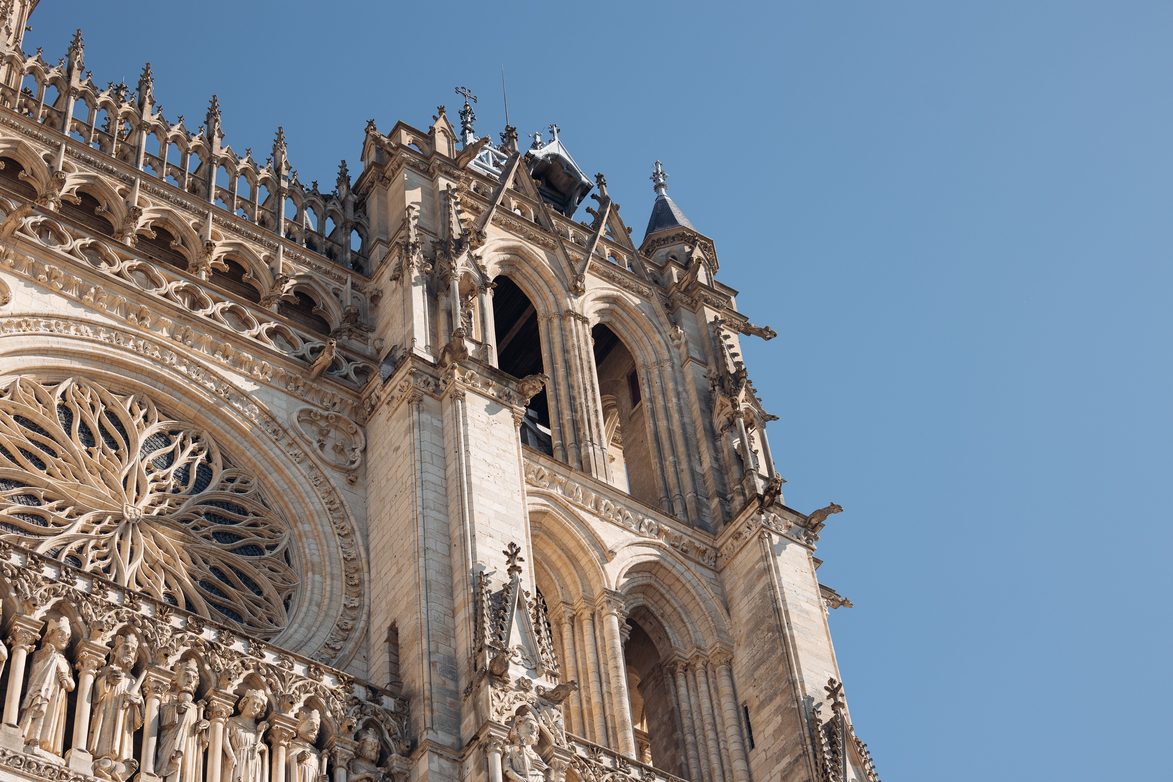Close-up of the carved Gothic portals, gables and rose window of Amiens Cathedral's west front