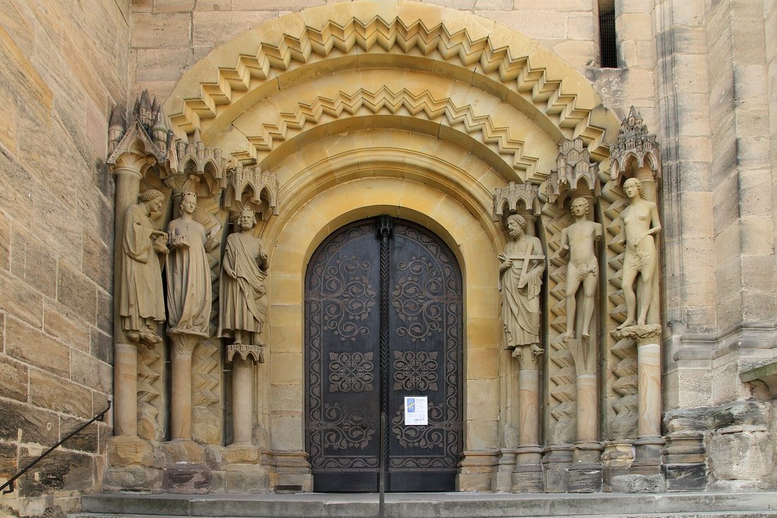 The Adamspforte at Bamberg Cathedral, a Romanesque doorway flanked by standing stone figures including Adam and Eve