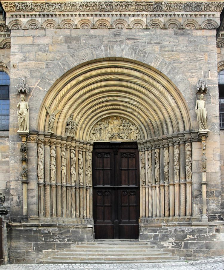 The deep round-arched Fürstenportal on the north side of Bamberg Cathedral, with statues on columns either side