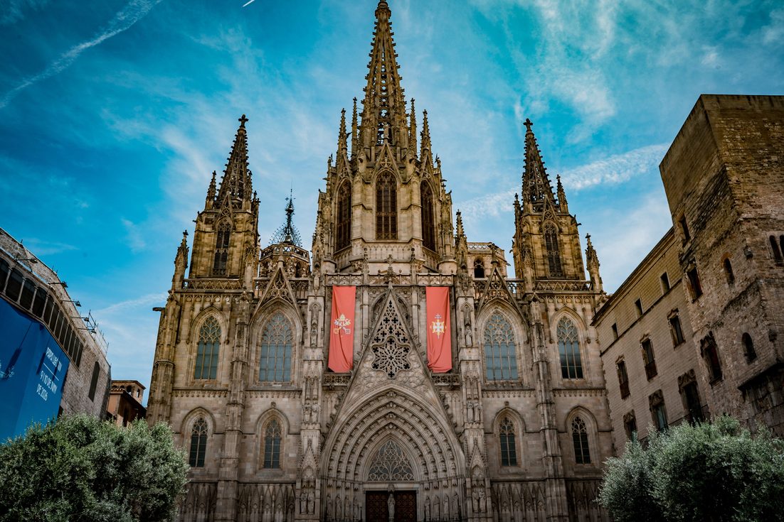 The neo-Gothic facade and spires of Barcelona Cathedral rising above the Pla de la Seu