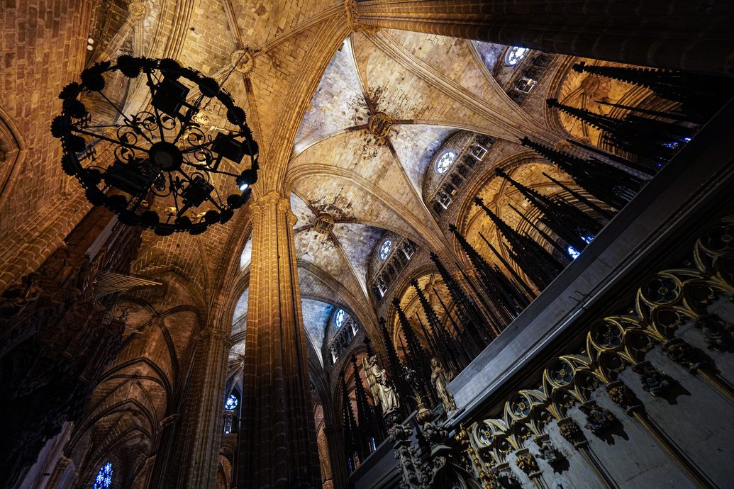 The ribbed Gothic vaults of Barcelona Cathedral with a hanging chandelier
