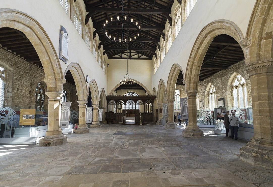 The empty medieval nave of St Peter's, Barton-upon-Humber, with stone arcades and display cases