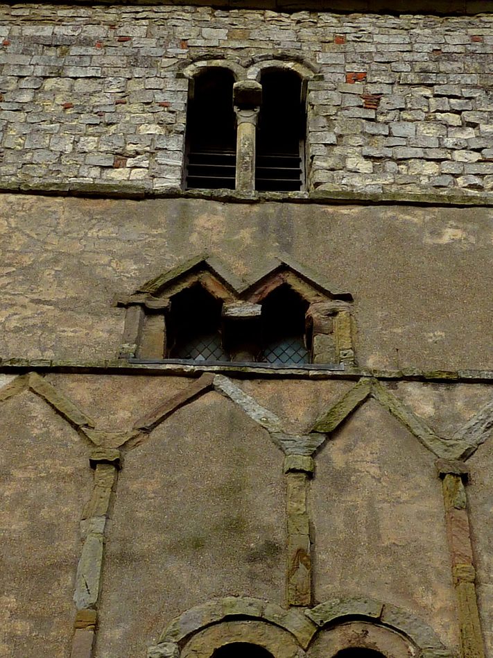 Small paired Anglo-Saxon windows with triangular and round heads in the tower of St Peter's, Barton-upon-Humber