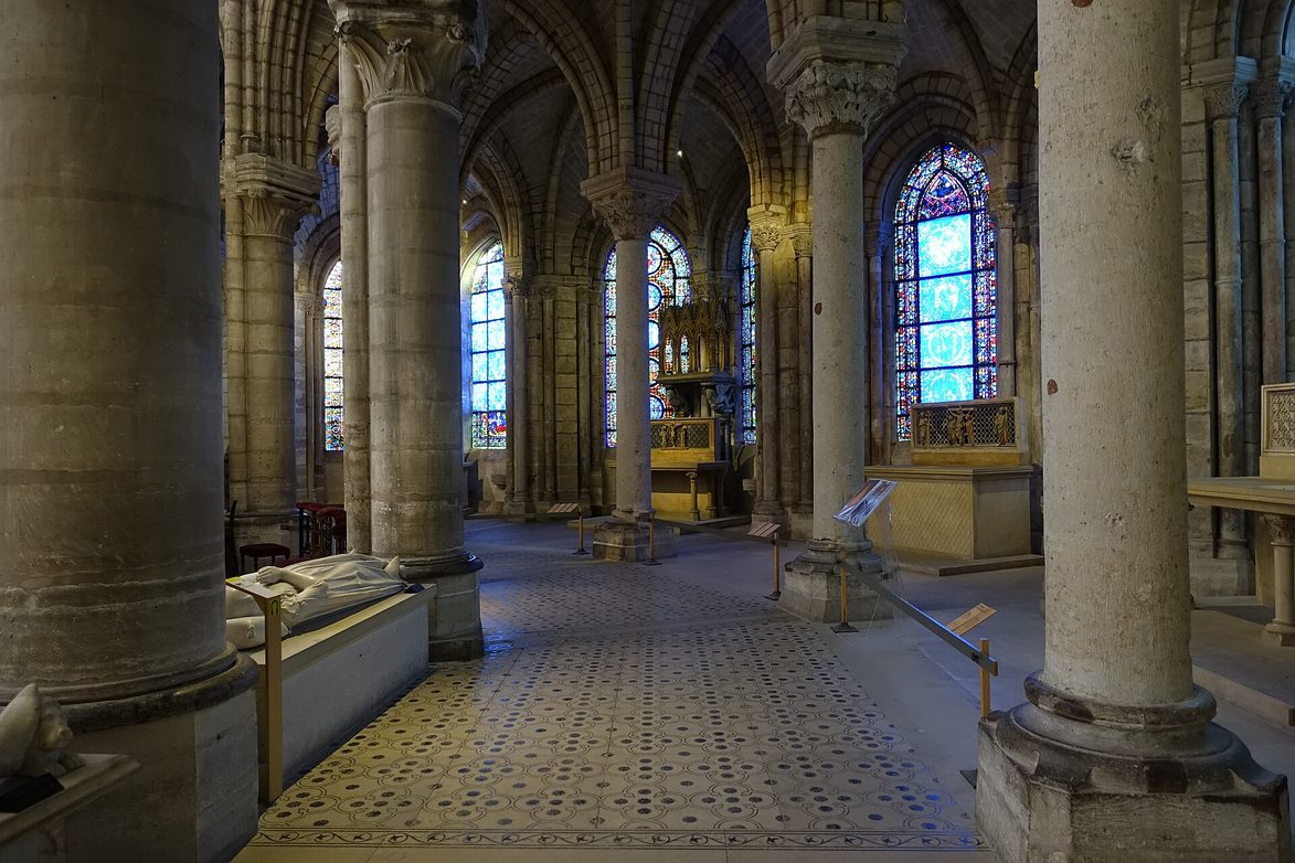 The ambulatory of the Basilica of Saint-Denis, with slender columns and stained glass in the radiating chapels
