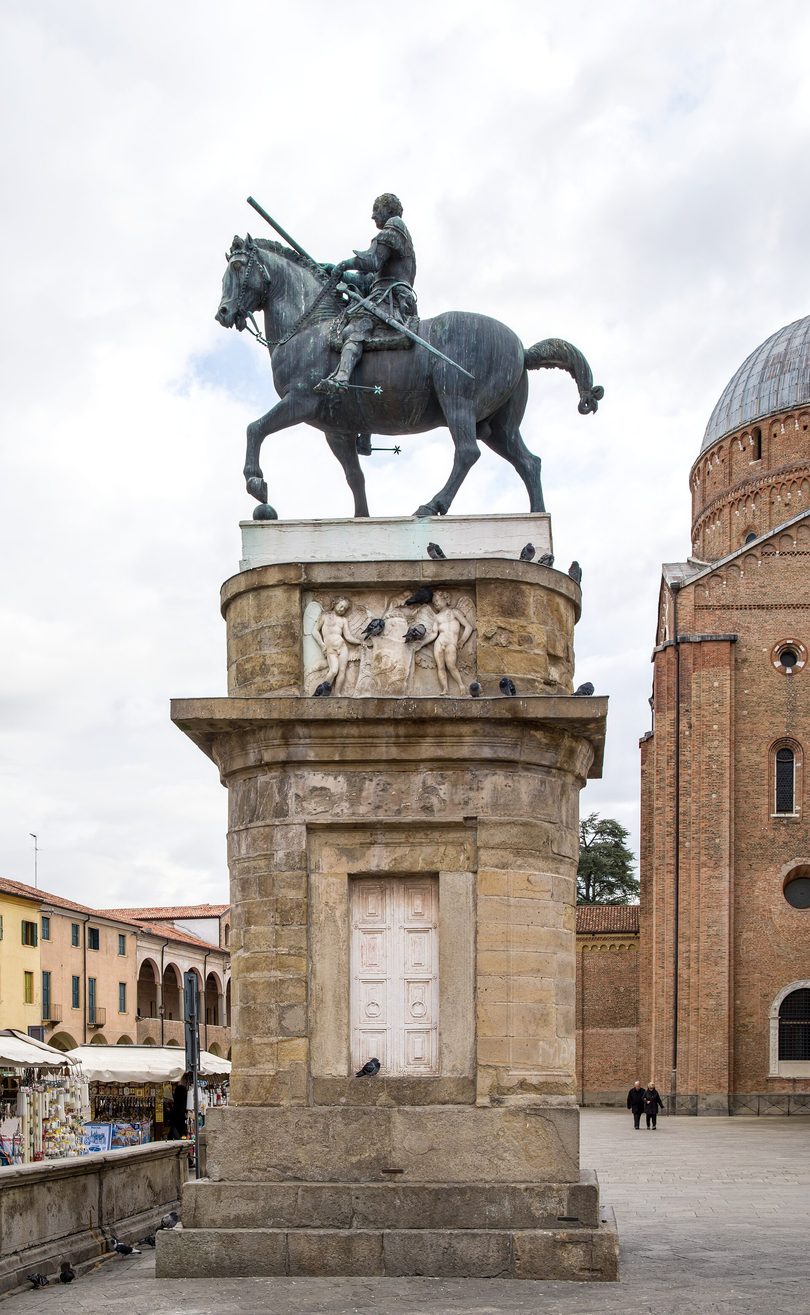 Donatello's bronze equestrian statue of Gattamelata on its tall stone pedestal in front of the basilica