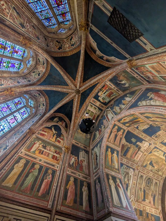 The painted vault over the high altar of the Lower Basilica in Assisi, with gold and blue allegorical frescoes