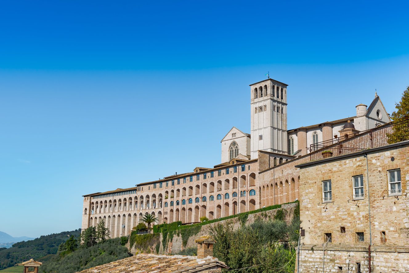 The long arcaded walls of the Sacro Convento and the basilica above the valley at Assisi