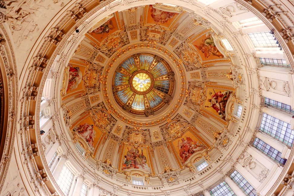 Looking up into the dome of Berlin Cathedral, with its painted and gilded decoration and ring of windows