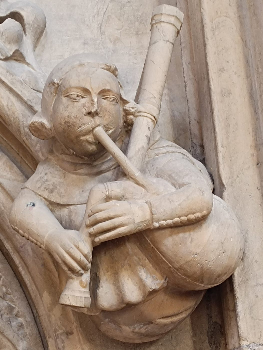 A medieval stone carving of a bagpiper in Beverley Minster