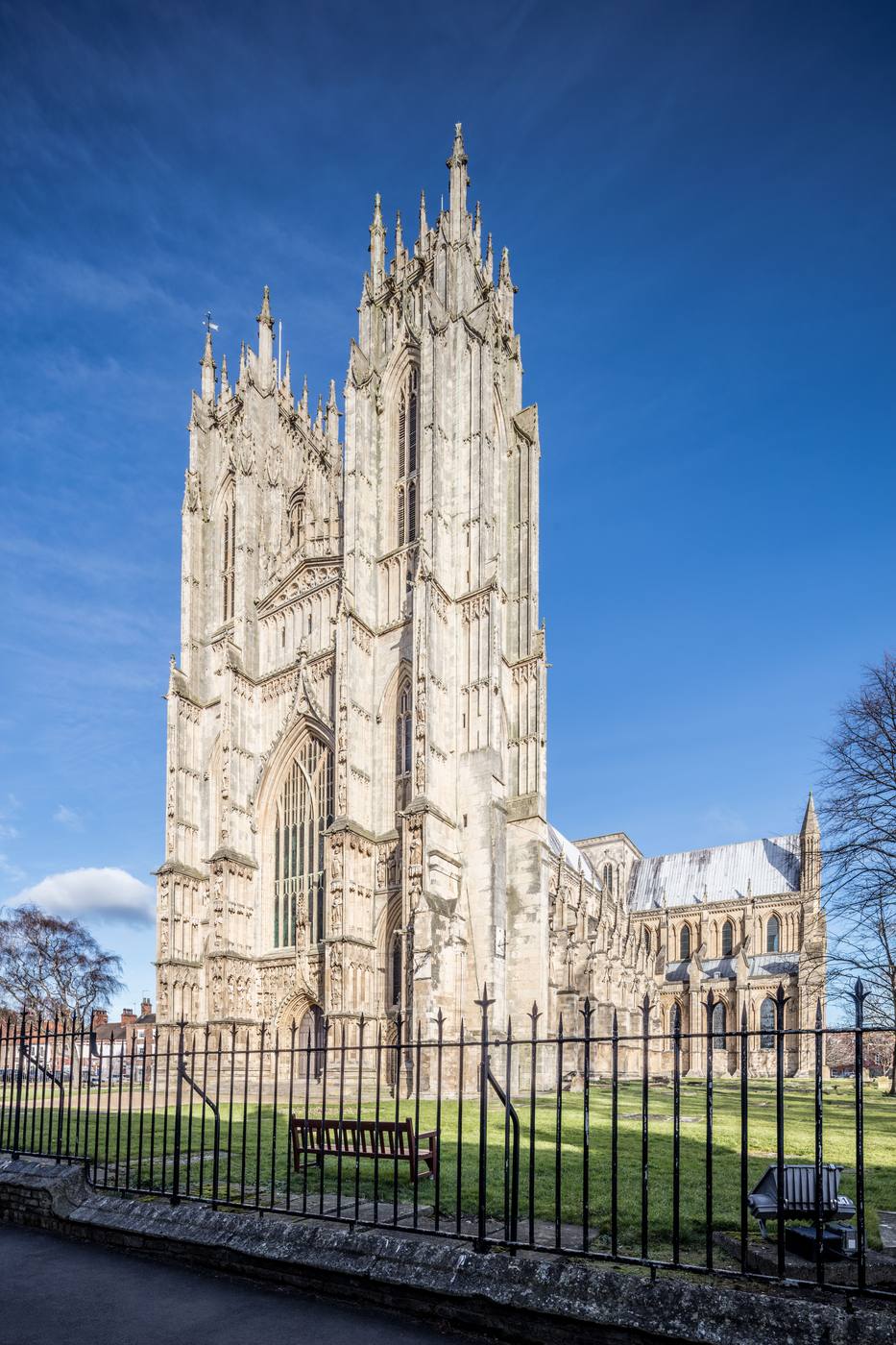 The twin Perpendicular west towers of Beverley Minster against a deep blue sky