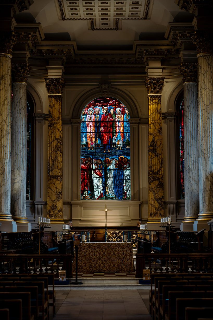The Ascension window by Edward Burne-Jones in Birmingham Cathedral, glowing red and blue between gilded columns