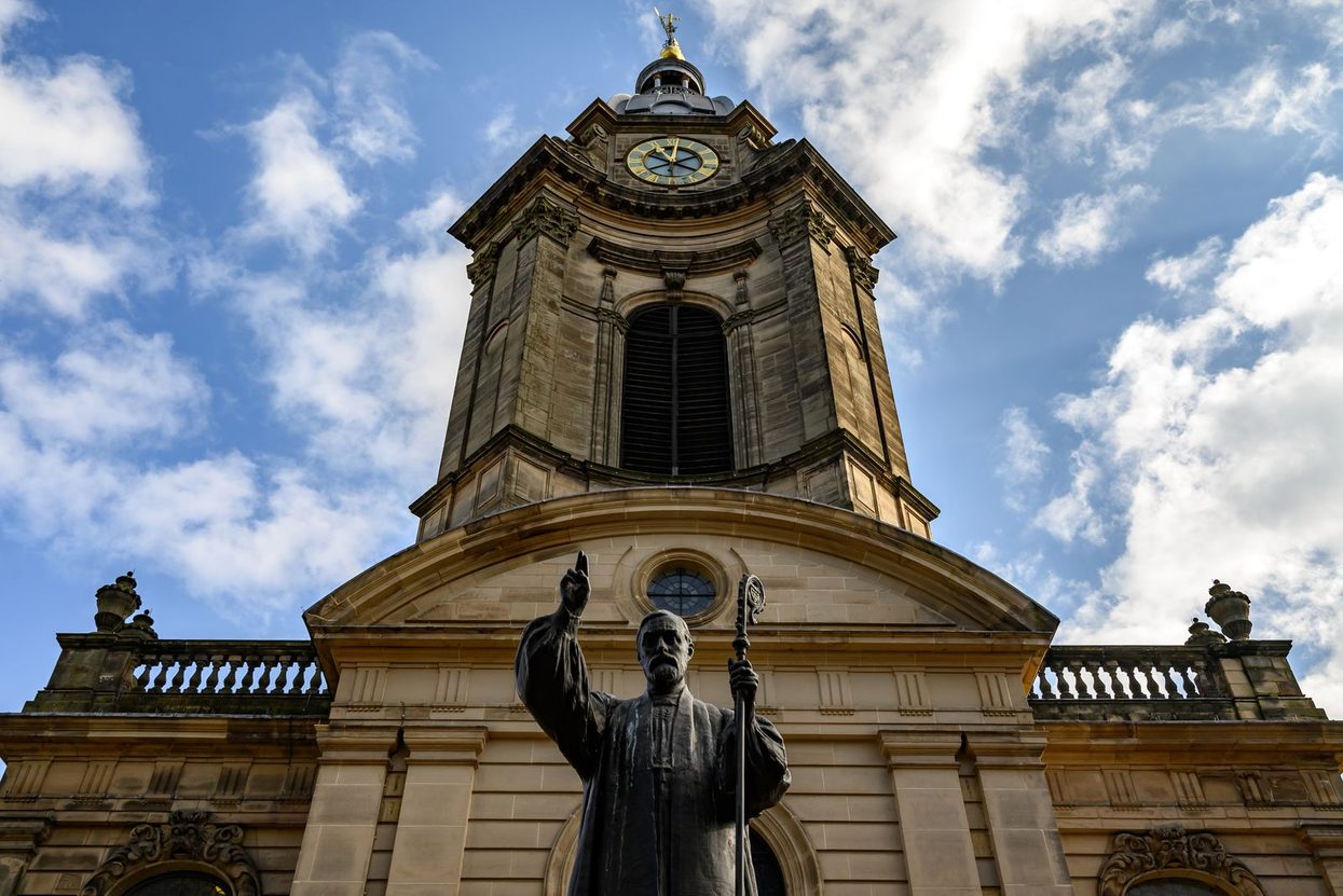 The west end of Birmingham Cathedral with the statue of Bishop Charles Gore in front of the tower