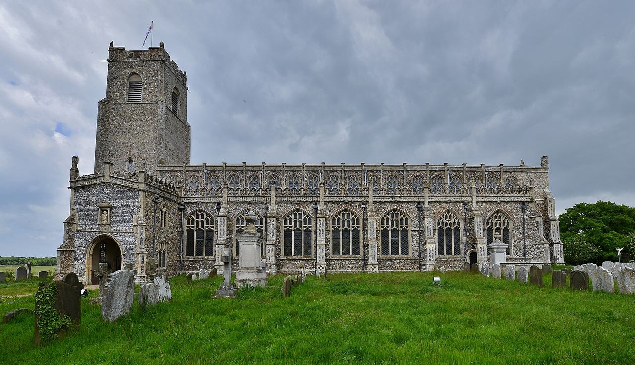 The long south side of Holy Trinity Church, Blythburgh, with its tower, porch and row of clerestory windows