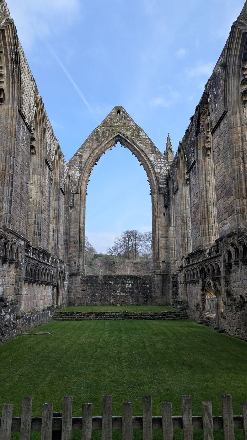 Looking along the roofless choir of Bolton Priory to its tall pointed east window