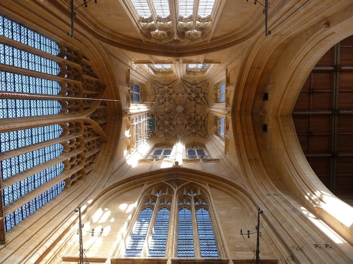 Looking up inside the tower of St Botolph's to its high stone vault and tall windows