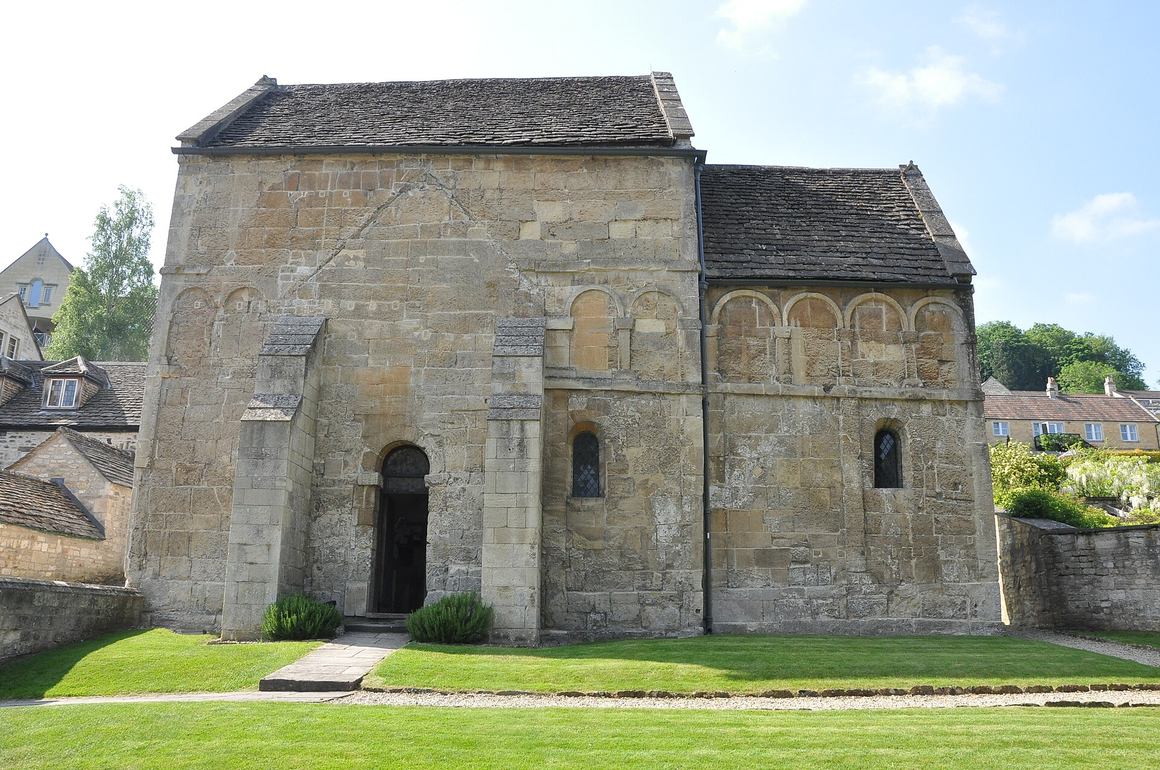 Close view of the shallow blind arcading of pilasters and round arches on the outer walls of the Saxon church