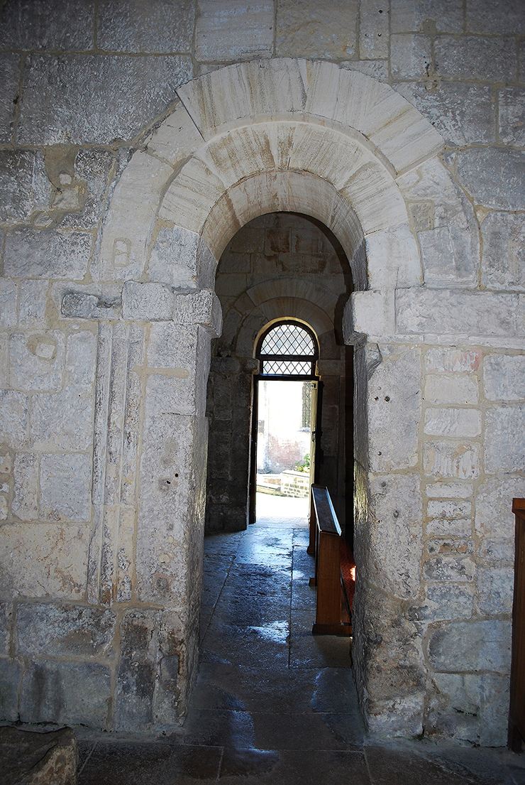 The narrow, tall nave of the Saxon church looking through the small chancel arch