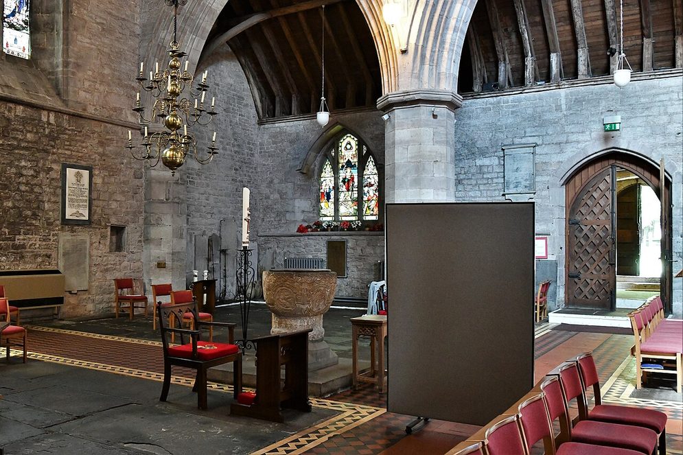The carved Norman font of Brecon Cathedral beside the north doorway, the main entrance