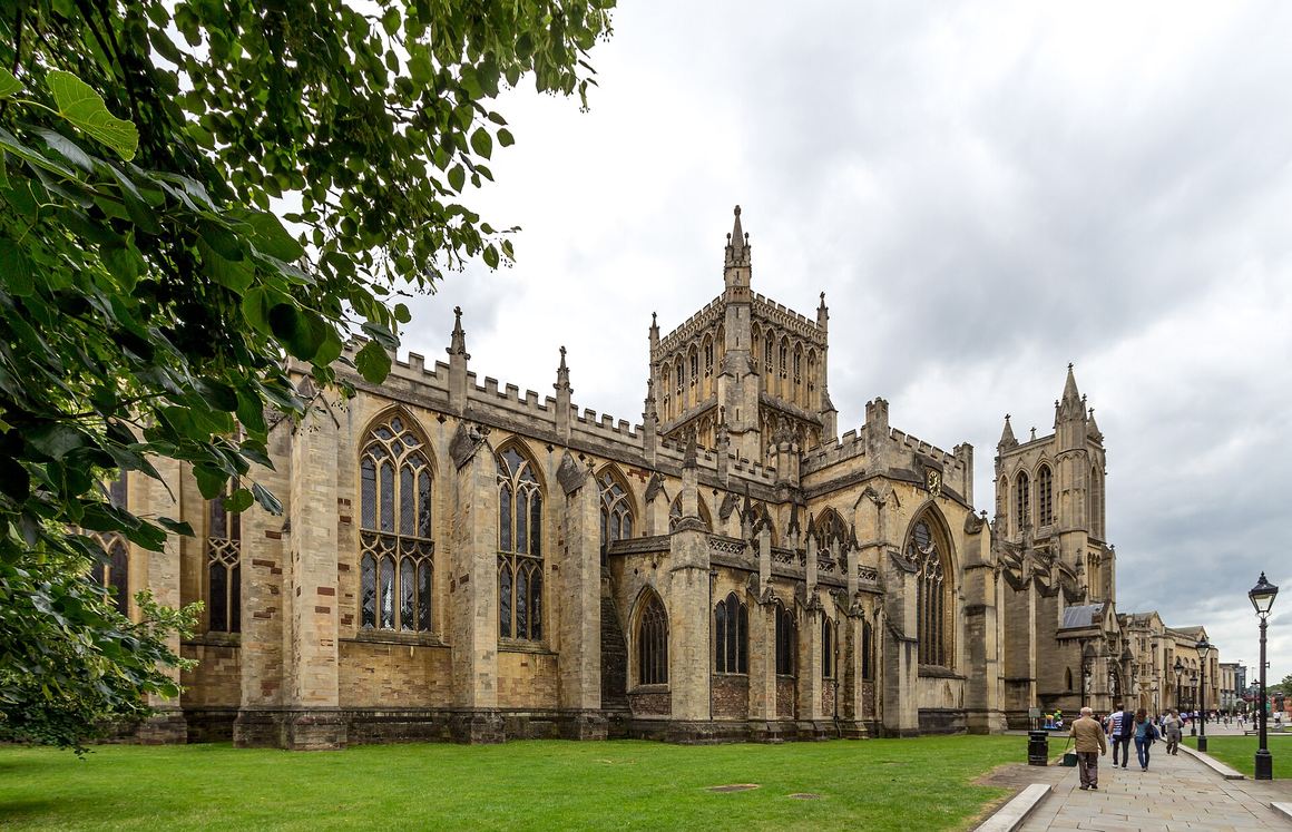 Bristol Cathedral seen across College Green, with its central tower and twin western towers