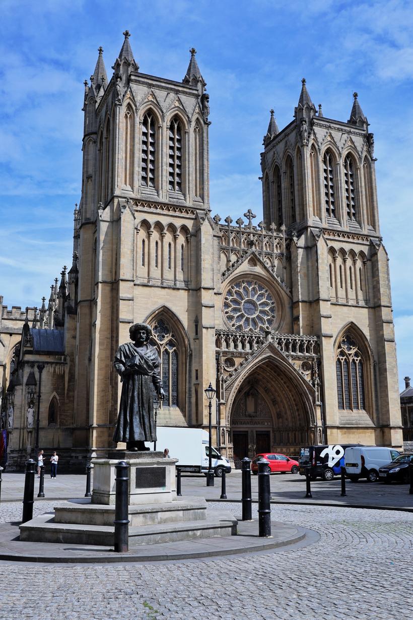 The twin-towered west front of Bristol Cathedral with a statue in front