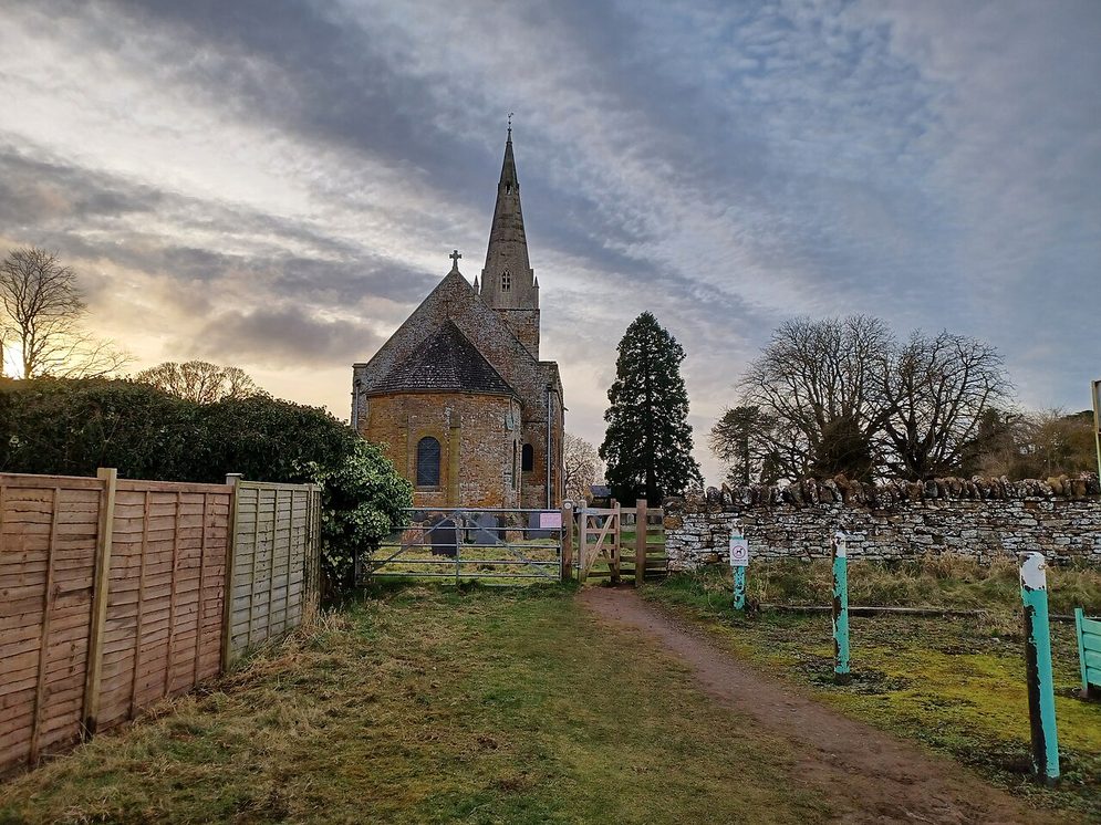 All Saints' Church, Brixworth, Northamptonshire, seen across the churchyard from the east, with its rounded apse and tall broach spire