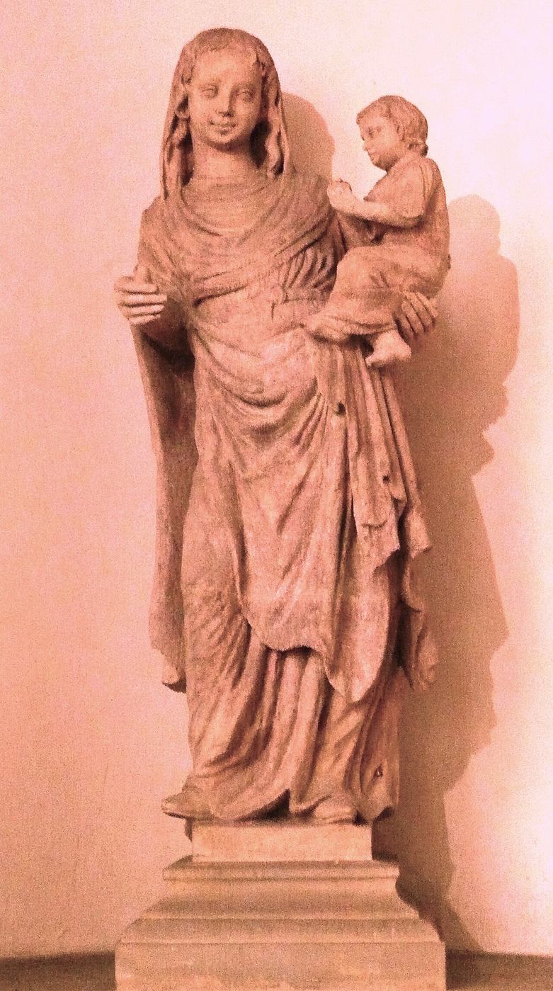 A medieval stone statue of the Virgin holding the Christ Child in Brno cathedral