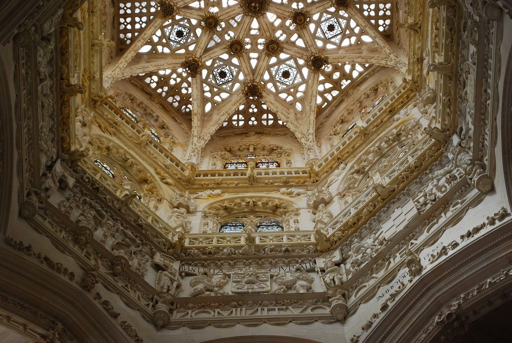 Looking up into the crossing lantern of Burgos Cathedral, an eight-pointed star vault of openwork stone