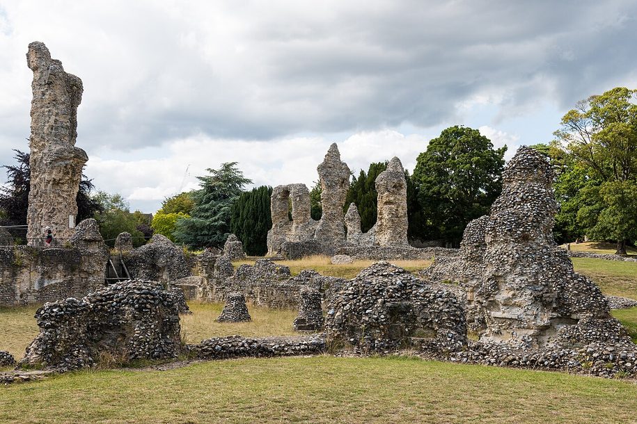 Flint rubble ruins of Bury St Edmunds Abbey standing in the grass of the Abbey Gardens