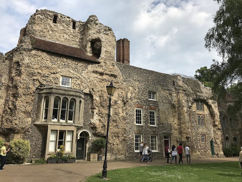 Houses with sash windows built into the ruined flint west front of Bury St Edmunds Abbey church