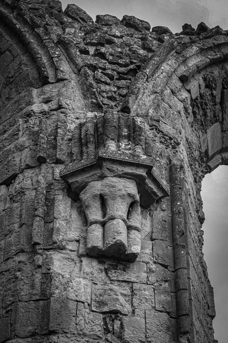 Black and white detail of carved stonework and a corbel at Byland Abbey