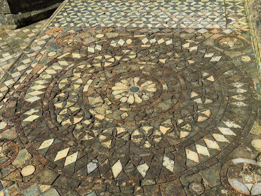 Medieval green and yellow glazed floor tiles laid in geometric patterns at Byland Abbey