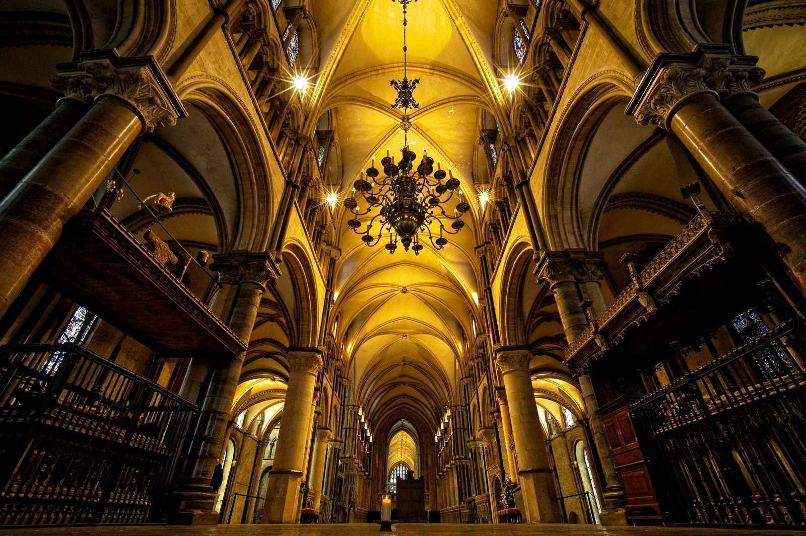 The Gothic nave of Canterbury Cathedral, its arched ceiling and hanging lights