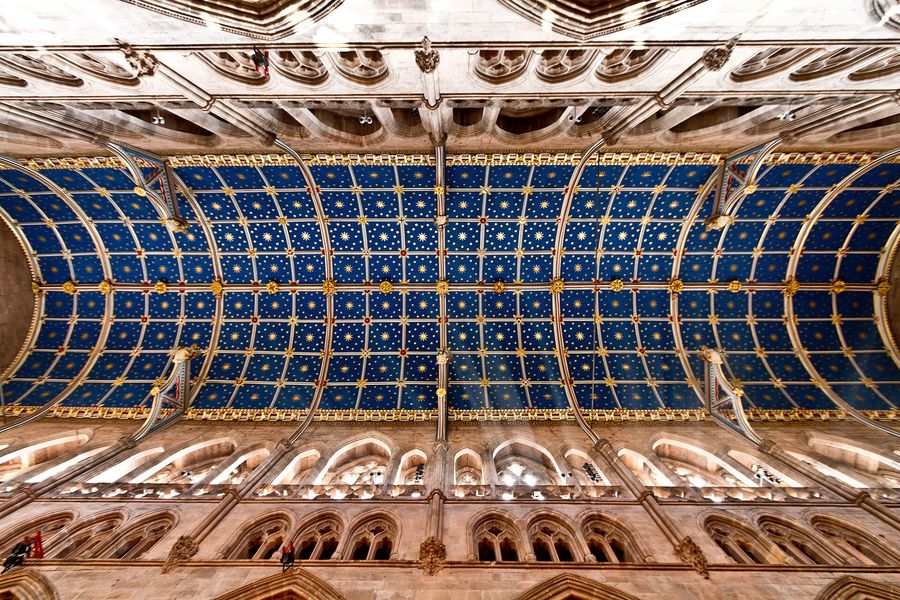 The barrel-vaulted wooden ceiling of Carlisle Cathedral's choir painted blue with gold stars