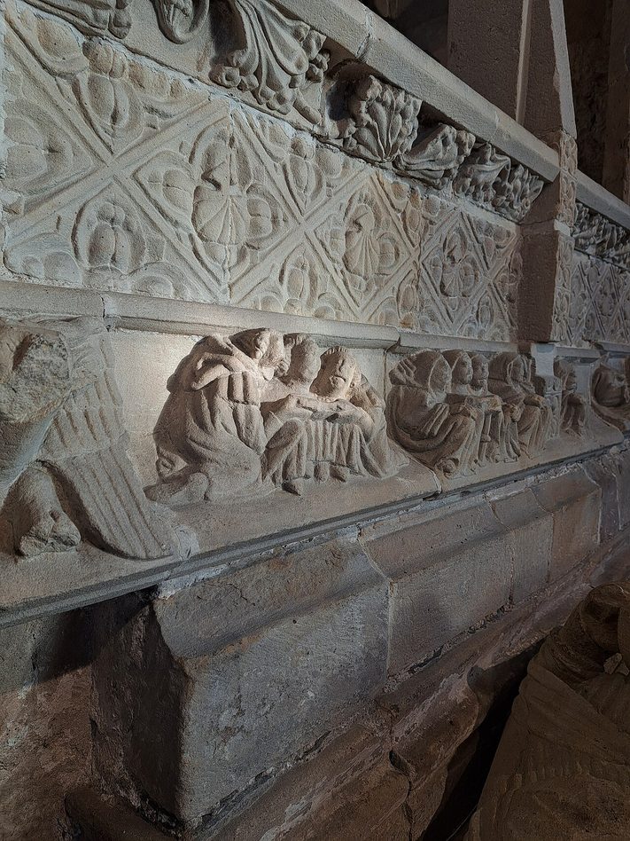Carved figures of mourning canons on the side of the Harrington tomb at Cartmel Priory