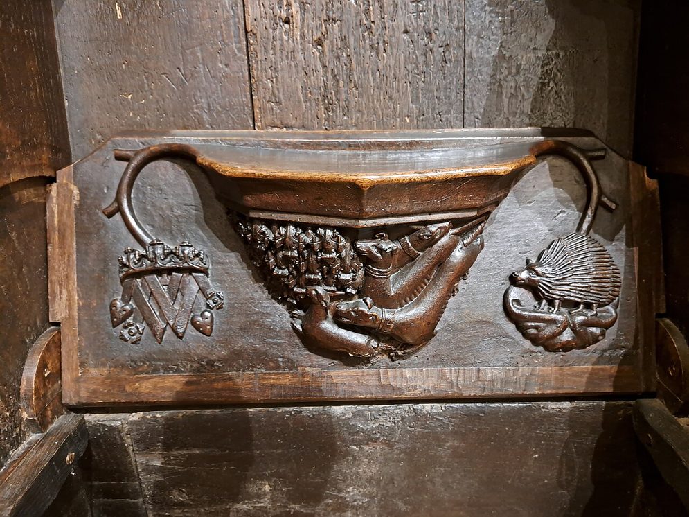 A carved wooden misericord in the choir stalls of Cartmel Priory