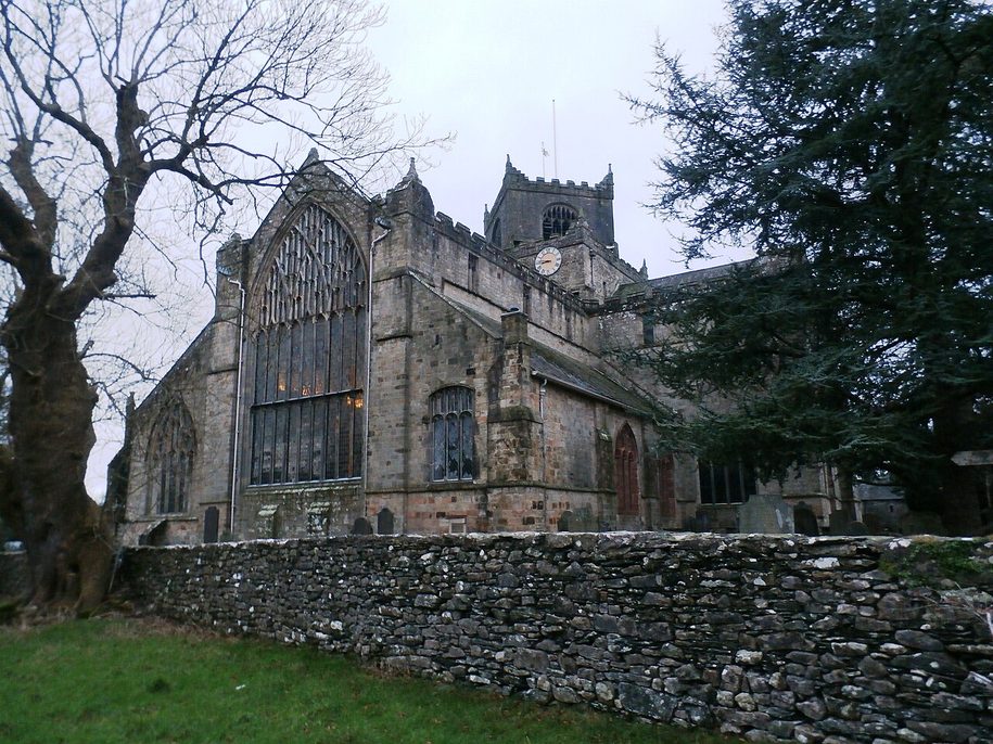 The tower of Cartmel Priory, its upper belfry turned at forty-five degrees to the square base below