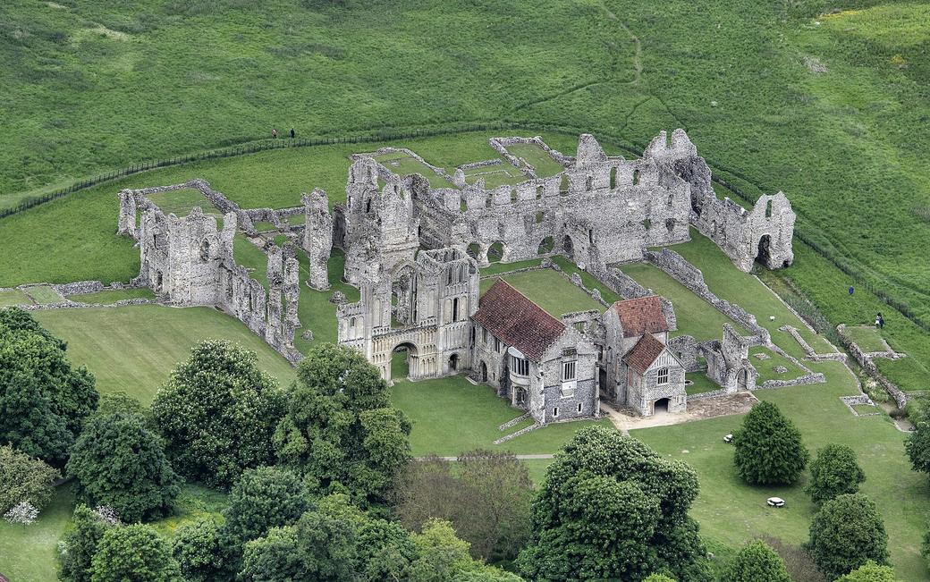 Aerial view of the ruins of Castle Acre Priory, with the roofed prior's lodging beside the church