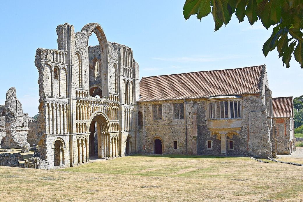The west front of Castle Acre Priory church with its Norman arcading, and the prior's lodging beside it