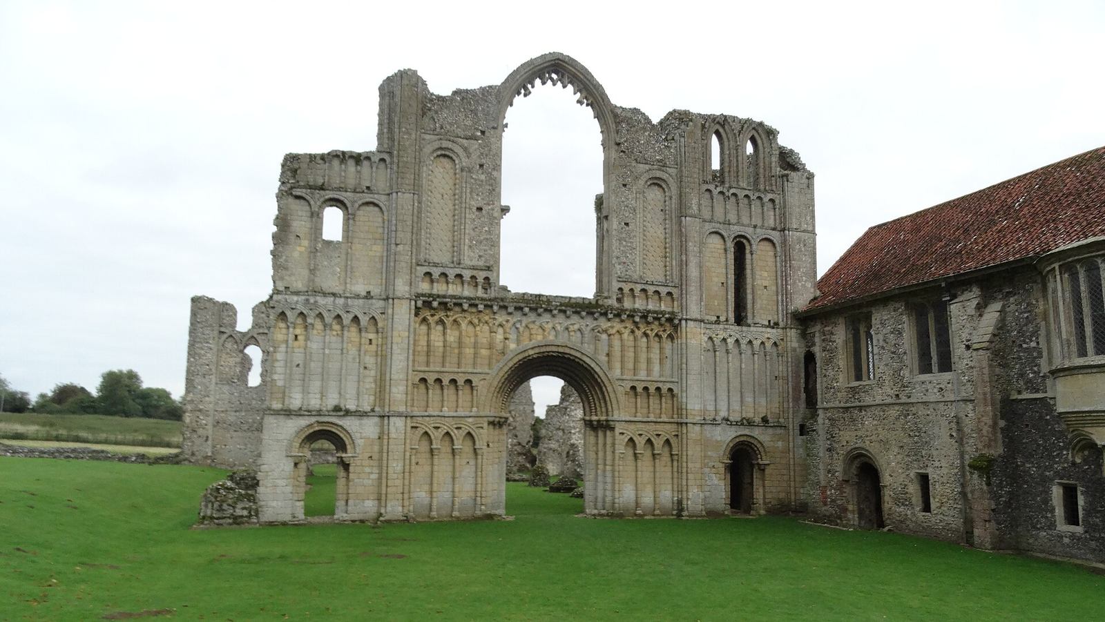 The ruined west front of Castle Acre Priory with its tiers of round-headed Norman arcading