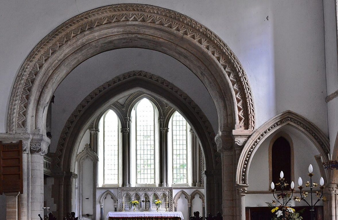 A richly carved round Norman arch with zigzag mouldings beneath the central tower of Castle Rising church