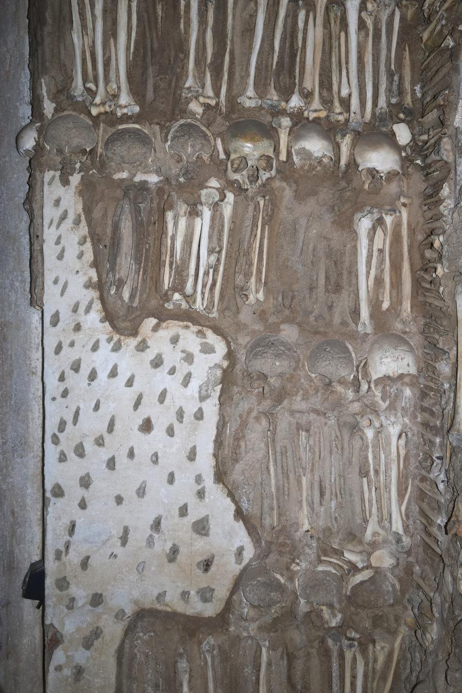 Skulls and long bones arranged on a pillar in the Chapel of Bones, Evora