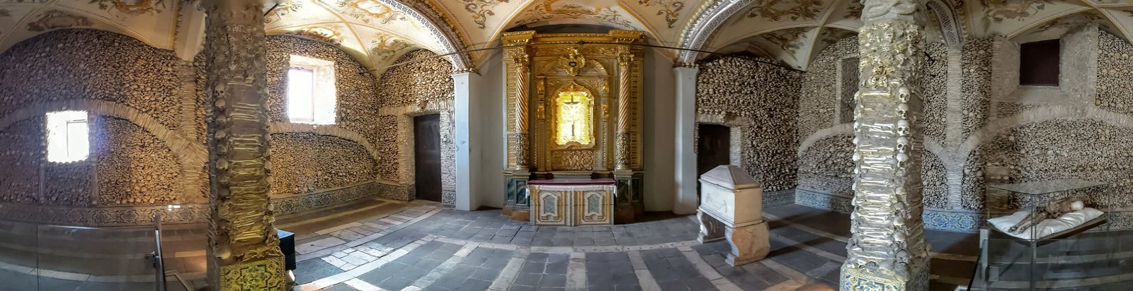 A wide view of the bone-lined interior of the Chapel of Bones, Evora
