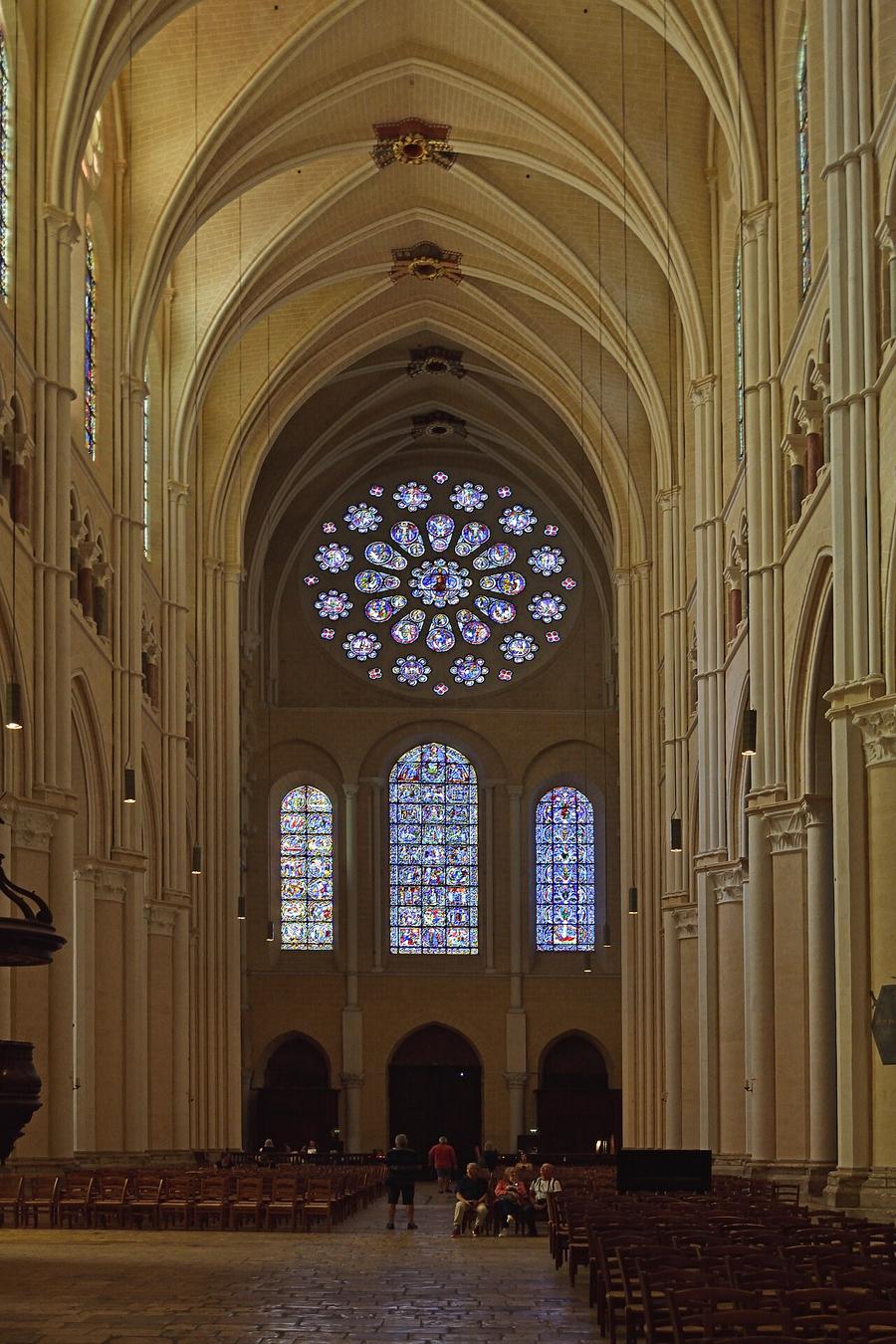 The pale restored nave of Chartres Cathedral looking west towards the west rose