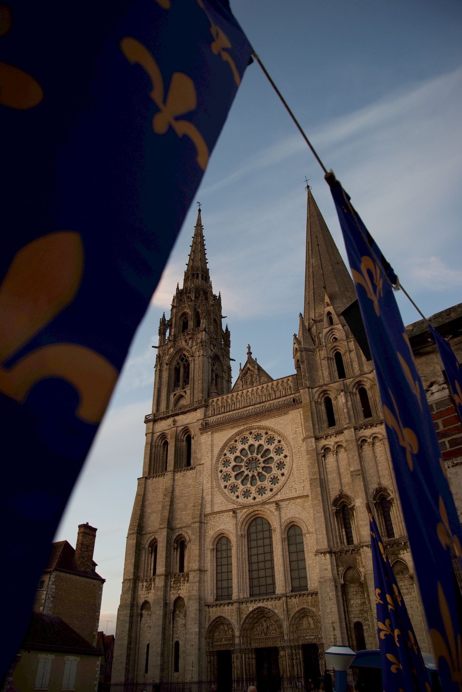 The west front of Chartres Cathedral framed by blue flags with gold fleurs-de-lis