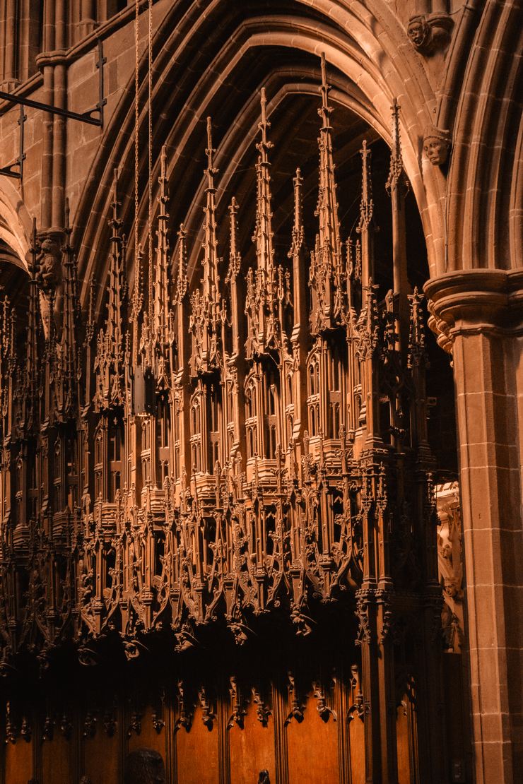 Close view of the intricately carved wooden canopies above the quire stalls at Chester Cathedral