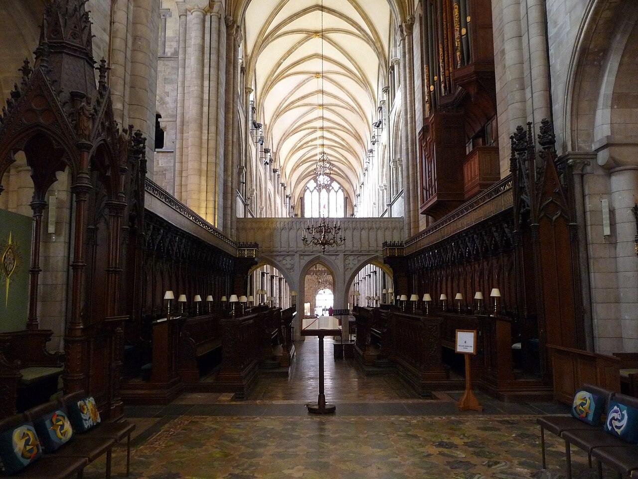 The quire of Chichester Cathedral with carved stalls, looking west towards the nave